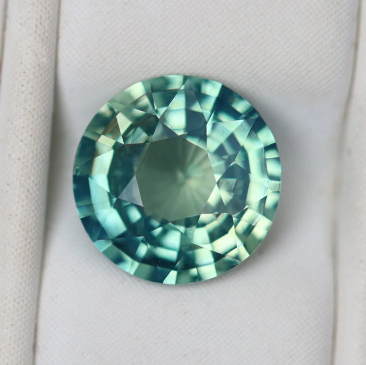 1.11 Ct Round Cut Bi-Color Teal Green Sapphire, 6.5mm x 6.5mm x 3.4mm By Valley Rose