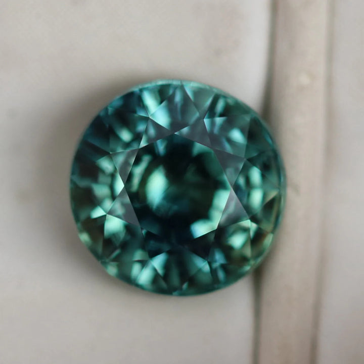 1.55 Ct Round Cut Bi-Color Teal Green Sapphire, 6.4mm x 6.4mm x 4.6mm By Valley Rose