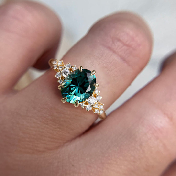 Unique Vintage Engagement Ring with Oval Cut Teal Sapphire on hand